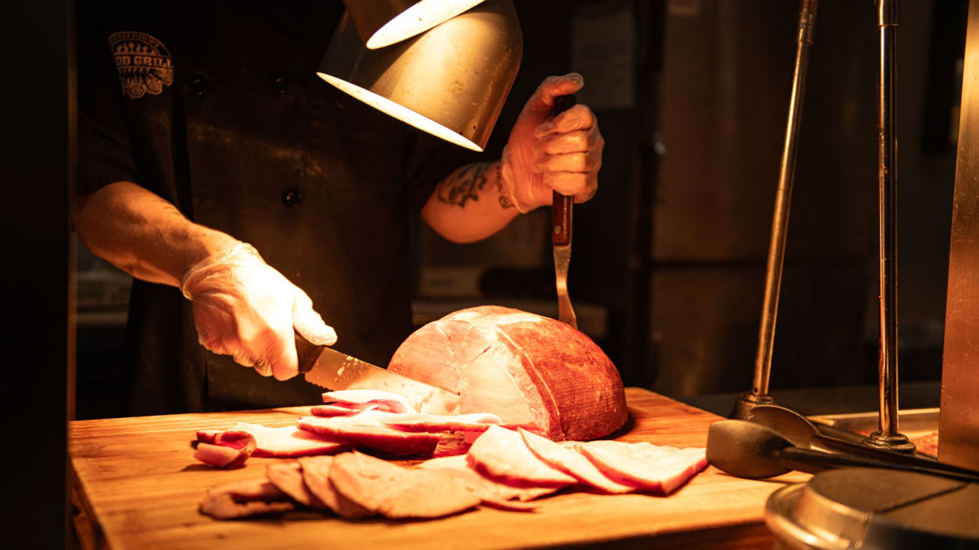 ham being carved at wood grill buffet