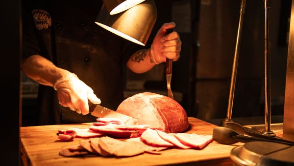 ham being carved at wood grill buffet